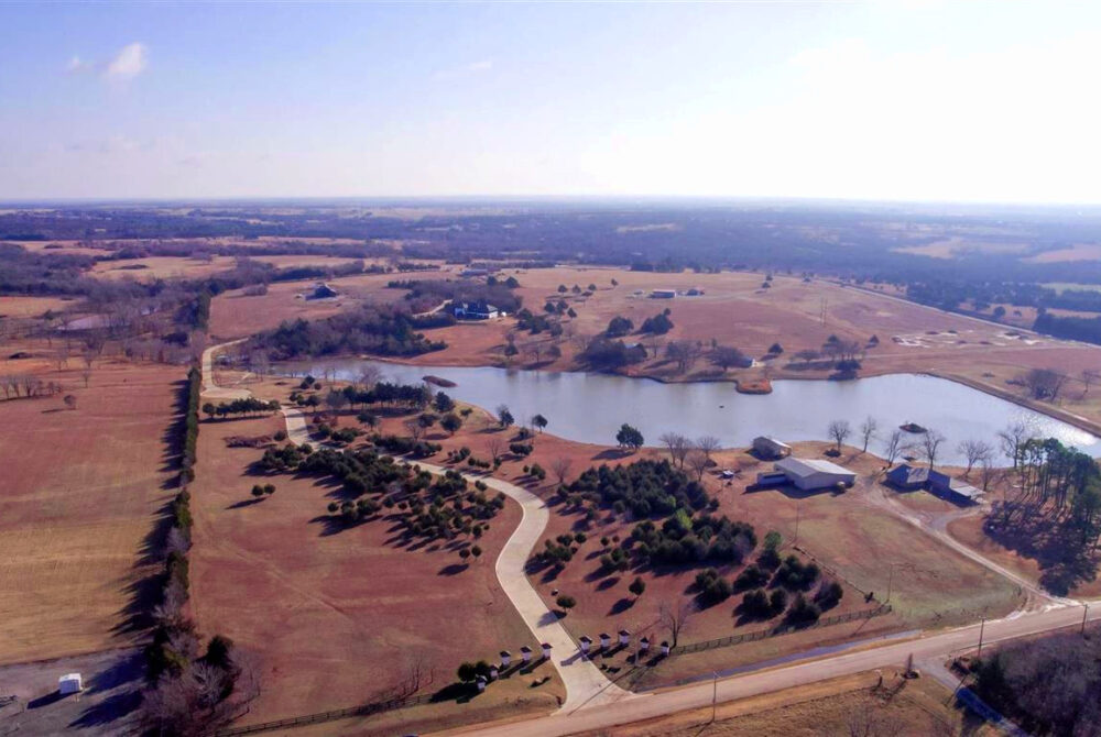 Overview image of large acre land with small lake to showcase investing in land for sale in stillwater ok