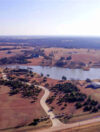 Overview image of large acre land with small lake to showcase investing in land for sale in stillwater ok